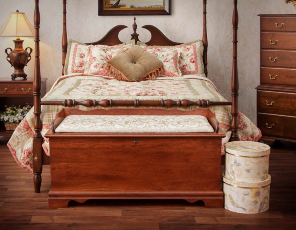 a cedar chest sitting at the foot of a bed is a creative use for a cedar chest