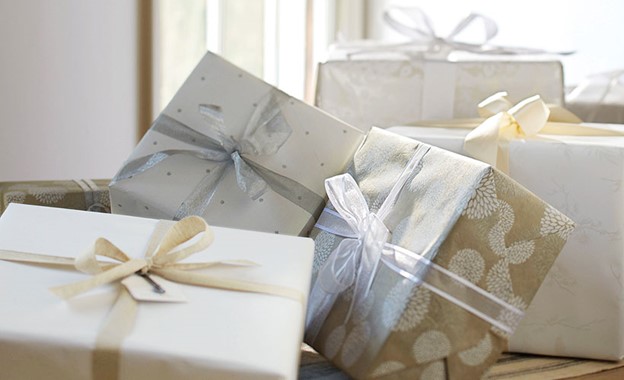 a pile of wrapped expensive wedding gift packages