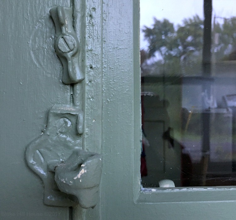 An Old Painted Door Hardware Such As Door Lock and Door Handle
